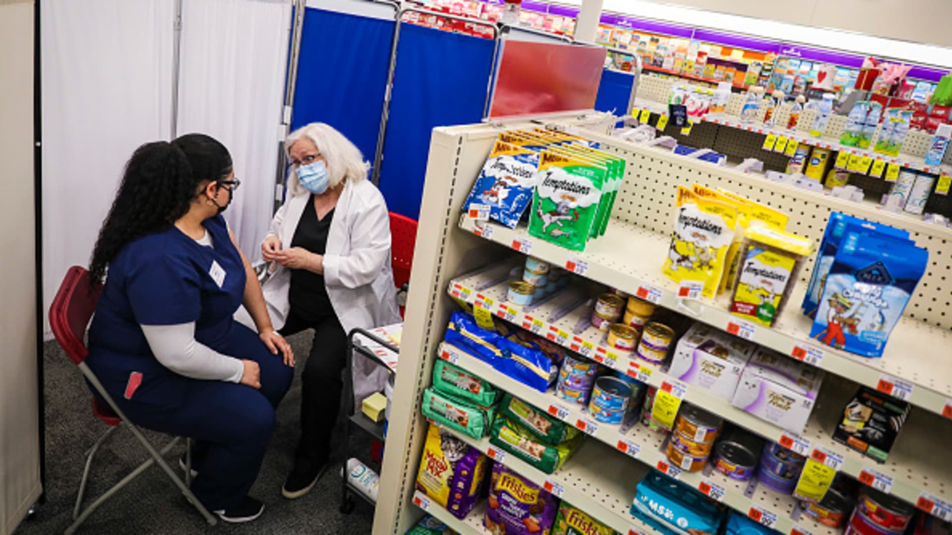 CVS Pharmacy Technician Leslie Carnejo, left, talks to RN Claire Karas after receiving the COVID-19 vaccine at a CVS in East Boston on Feb. 12, 2021.