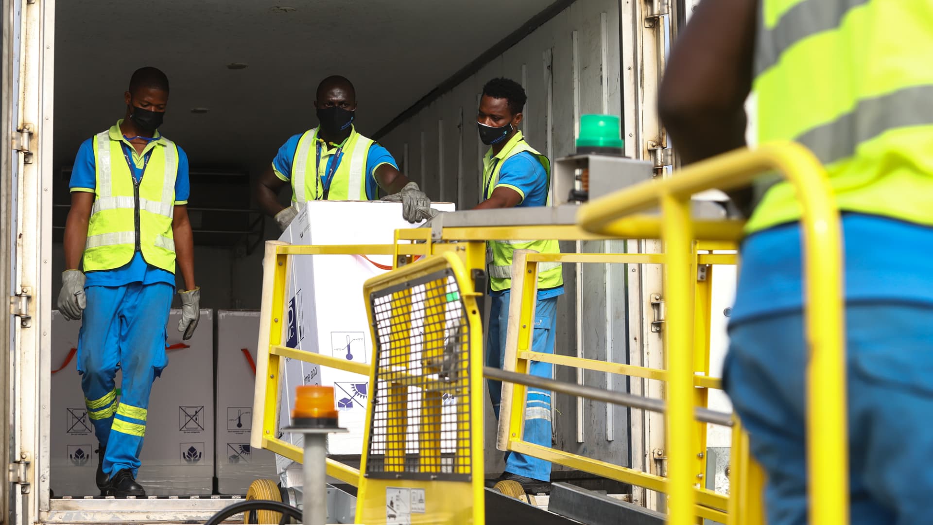 Airport workers unload a shipment of Covid-19 vaccines from the Covax global Covid-19 vaccination programme, at the Kotoka International Airport in Accra, on February 24, 2021.