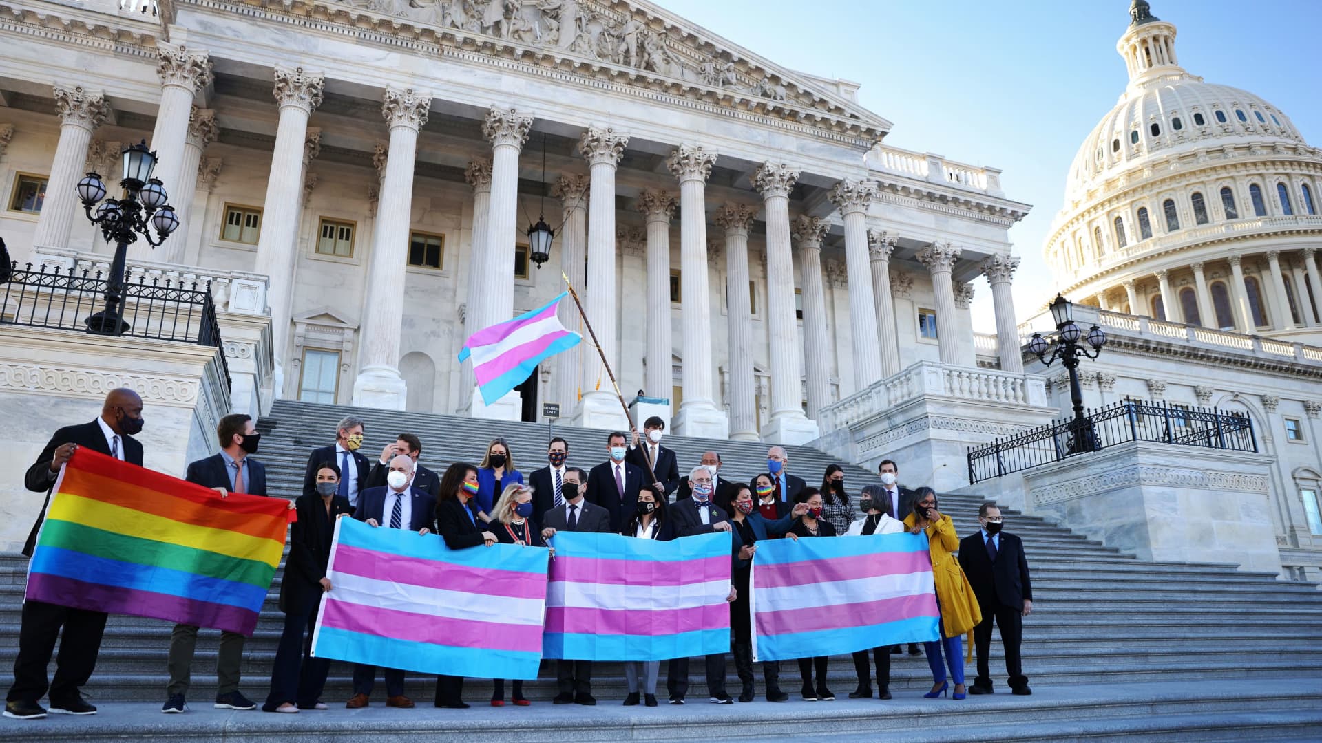 Democratic members of the U.S. House of Representatives pose for a photograph holding LBGT+ and Transgender Pride flags on the steps of the U.S. Capitol ahead of a vote on the Equality Act on Capitol Hill in Washington, February 25, 2021.