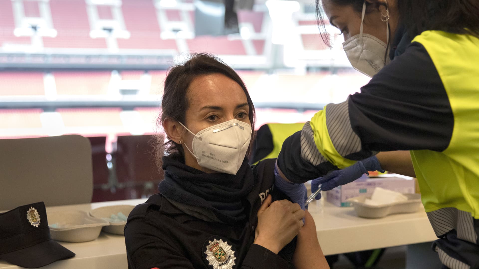 A police officer is vaccinated with AstraZeneca vaccine against Covid-19.