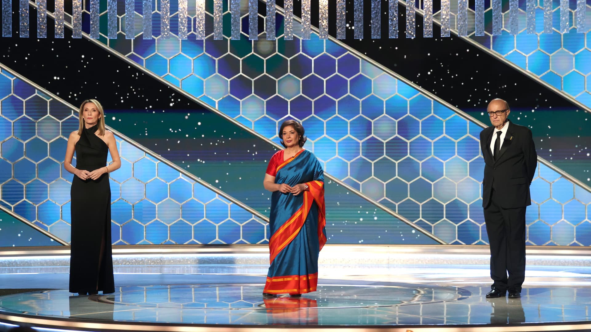 Pictured in this image released on February 28, (l-r) HFPA Vice President Helen Hoehne, HFPA Board Chair Meher Tatna, and HFPA President Ali Sar speak onstage at the 78th Annual Golden Globe Awards held at The Beverly Hilton and broadcast on February 28, 2021 in Beverly Hills, California.