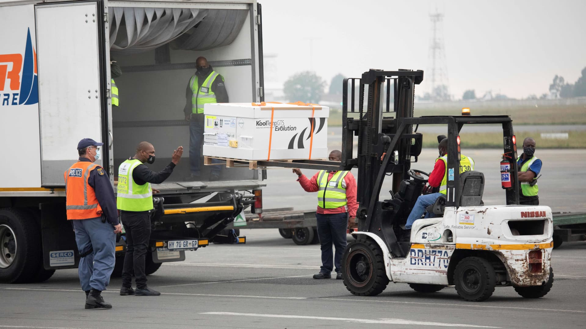 Workers transport the second shipment of the Johnson & Johnson Covid-19 coronavirus vaccine upon its arrival at the O R Tambo International Airport in Johannesburg on February 27, 2021.