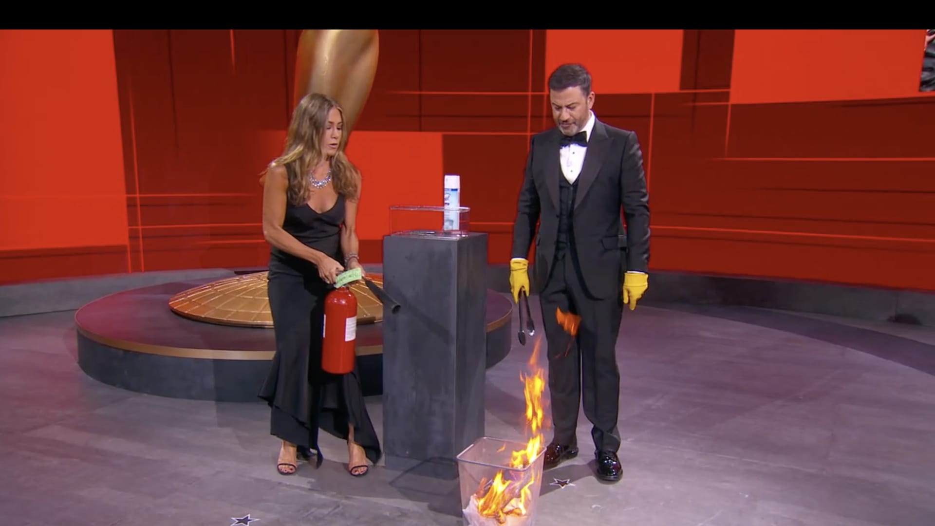 Host Jimmy Kimmel (right) and presenter Jennifer Aniston (right) work to put out a fire on the set of the 72nd Emmy Awards will broadcast SUNDAY, SEPT. 20 (8:00 p.m. EDT/6:00 p.m. MDT/5:00 p.m. PDT), on ABC. (ABC via Getty Images) JENNIFER ANISTON, JIMMY KIMMEL