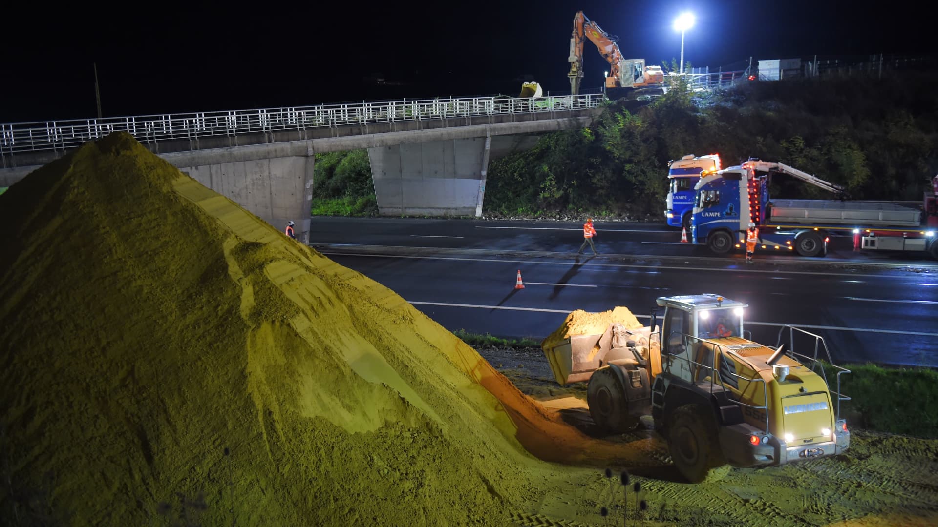 Construction cranes and vehicles cover the A10 highway between Paris and Bordeaux with sand on November 6, 2019 near Monts, central France.