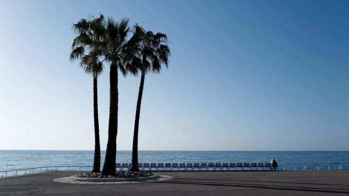 A picture taken on February 28, 2021 shows palm trees on the empty "Promenade des anglais" in Nice, on the French riviera.