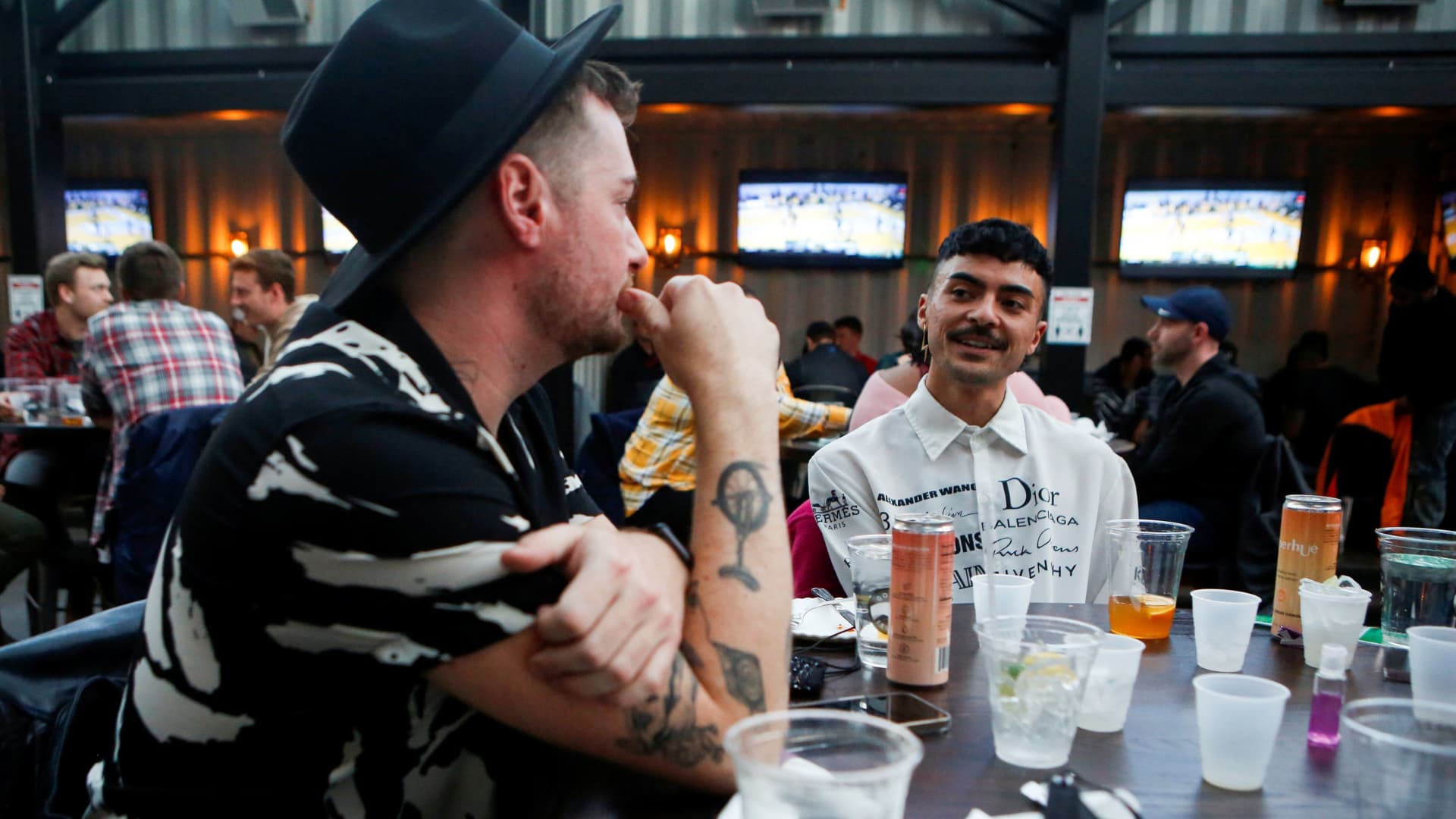 Knyckolas Davis (L) and Matthew Bettencourt celebrate Davis's 35th birthday with friends at Rizzo's Bar & Inn in Wrigleyville as coronavirus disease (COVID-19) restrictions are relaxed in Chicago, Illinois, U.S., March 6, 2021.