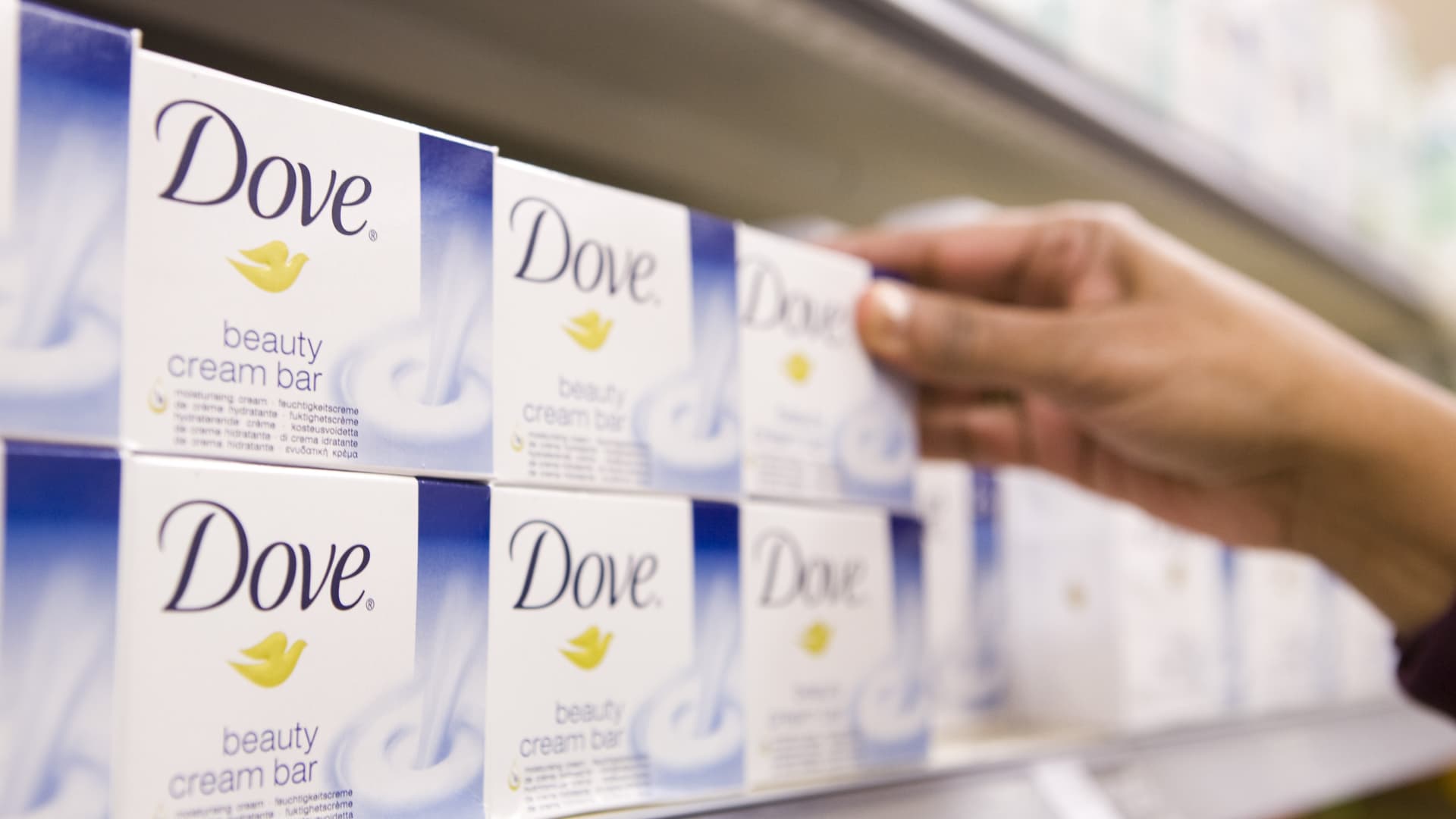 A customer selects bar of Dove soap, a Unilever product, at a Sainsbury's supermarket in London, U.K.