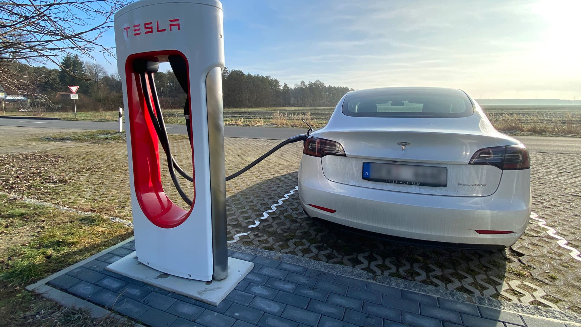 A Tesla Model 3 plugged in and charging at a Supercharger rapid battery charging station for electric vehicles in Bersteland, Germany, on March 02, 2021.