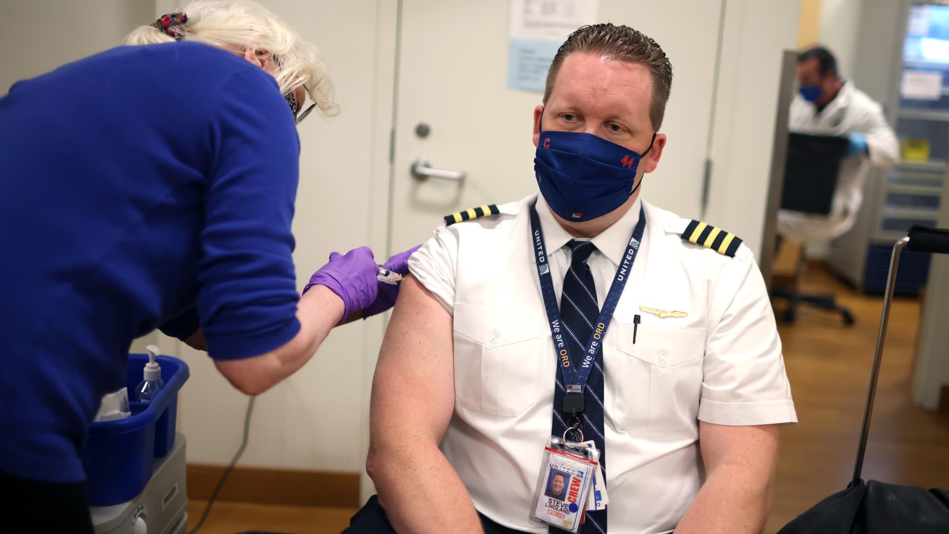 United Airlines pilot Steve Lindland receives a COVID-19 vaccine from RN Sandra Manella at United's onsite clinic at O'Hare International Airport on March 09, 2021 in Chicago, Illinois.
