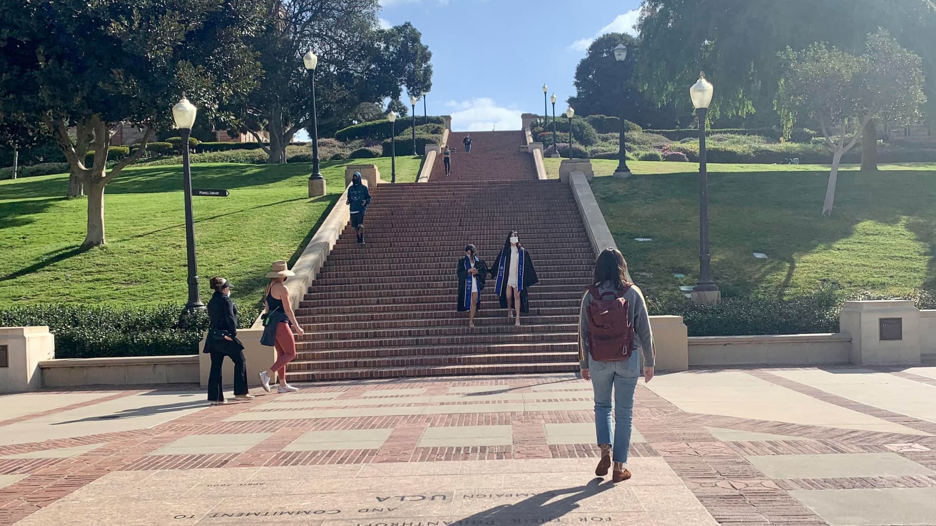 Students walk around Wilson Plaza on the UCLA campus in Los Angeles, Calif.