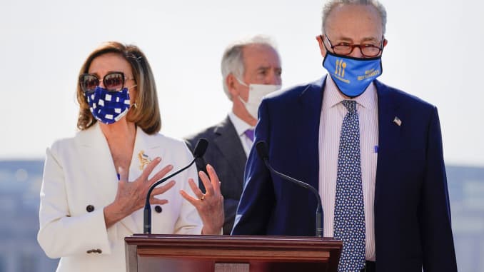House Speaker Nancy Pelosi of Calif., speaks as Senate Majority Leader Chuck Schumer of N.Y., listens during an enrollment ceremony for the $1.9 trillion COVID-19 relief bill, accompanied by Senate Majority Leader Chuck Schumer of N.Y., on Capitol Hill, W