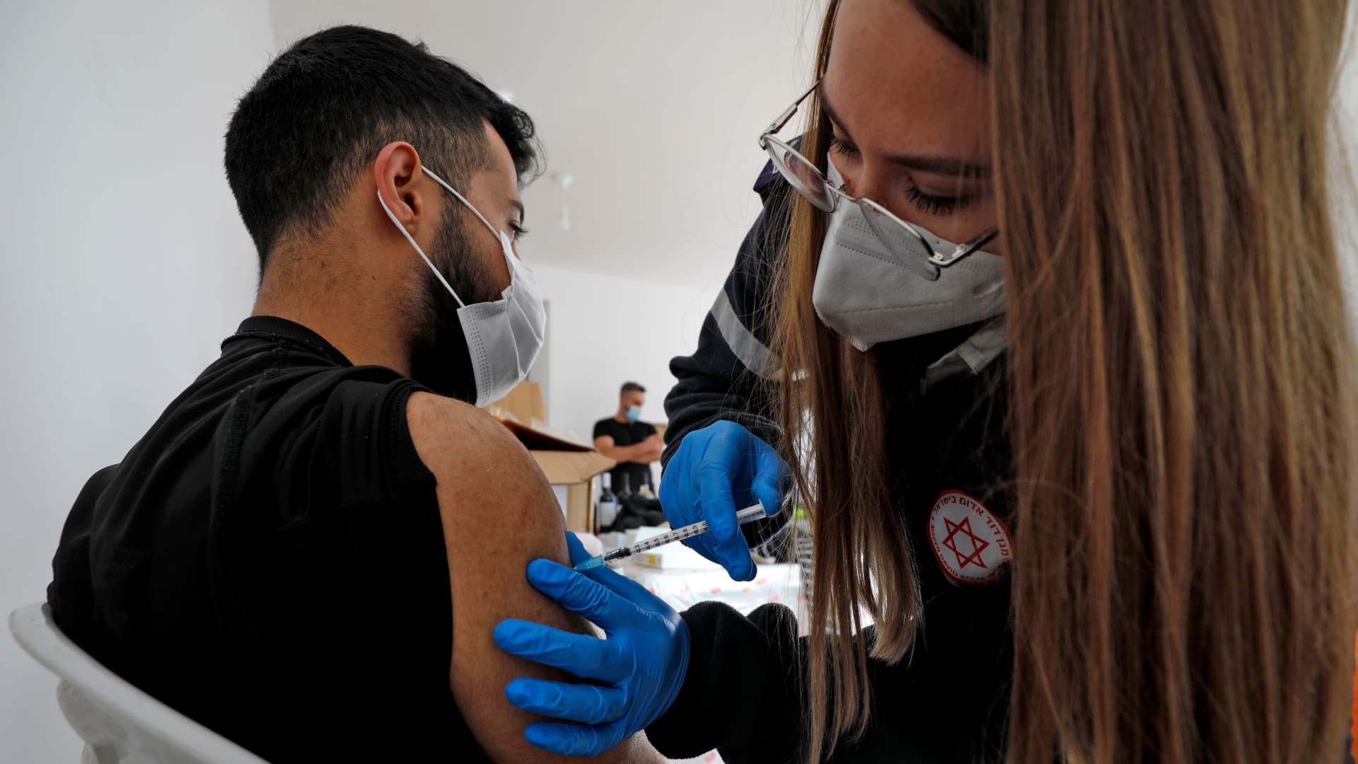 A health worker administers a dose of the Pfizer-BioNtech COVID-19 coronavirus vaccine at a mobile clinic near Moshav Dalton in northern Israel on February 22, 2021.