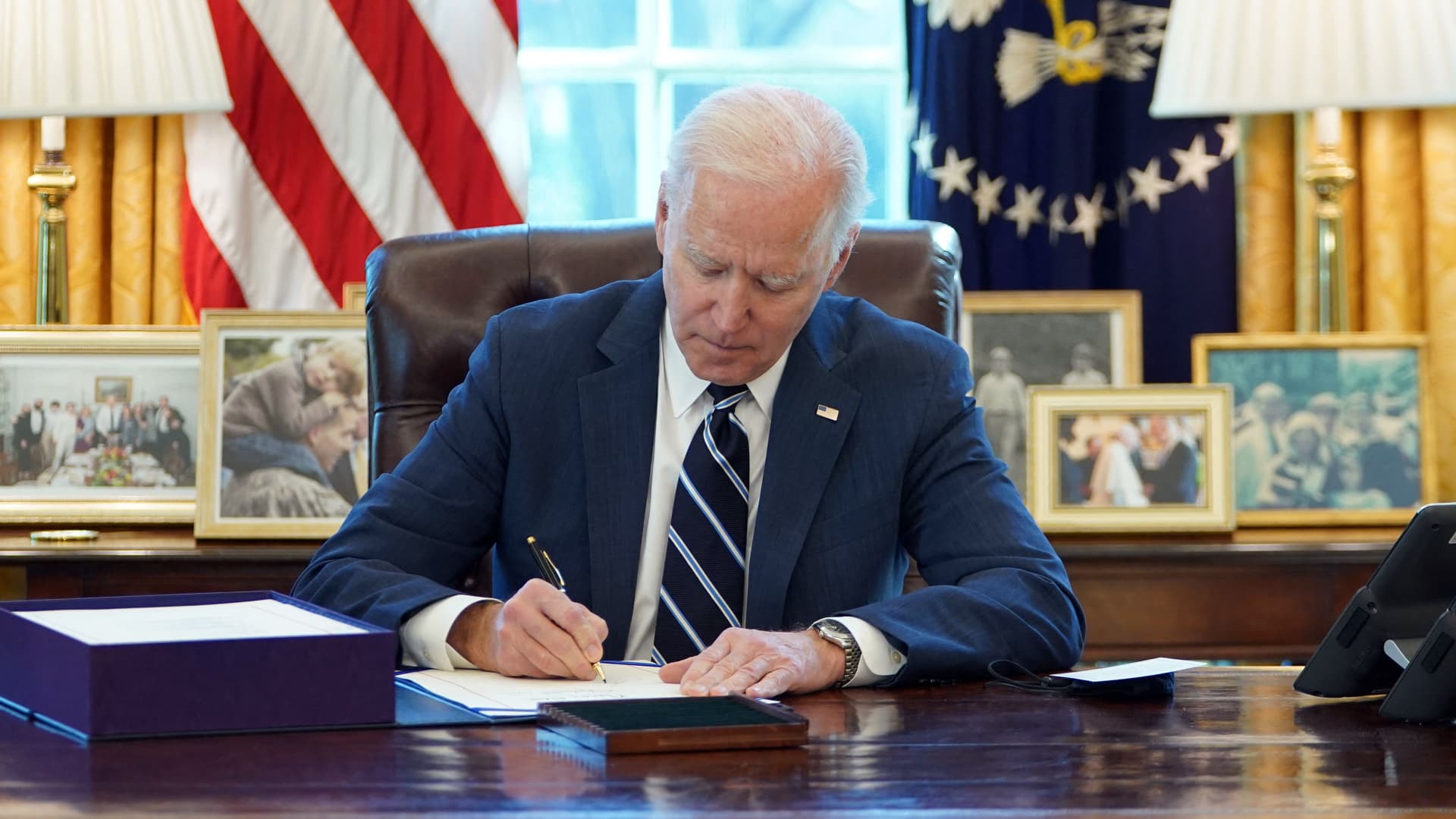 President Joe Biden signs the American Rescue Plan on March 11, 2021, in the Oval Office of the White House in Washington, DC.