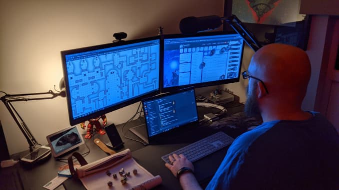 Davyd Atkins rolls digital dice on his D&D Beyond character sheet, accesses a map via his digital book from the D&D marketplace and uses the platform's Discord extension to play Dungeons & Dragons.