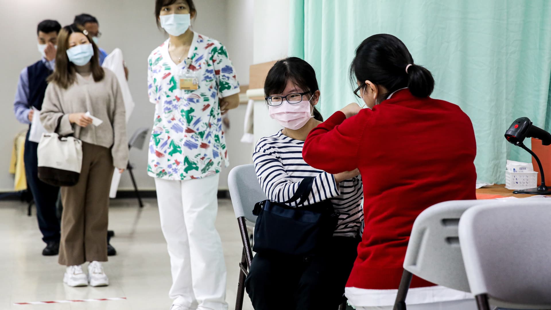 A healthcare worker receives the Oxford-AstraZeneca Covid-19 vaccine at Chang Gung Memorial Hospital in Taipei, Taiwan, on Monday, March 22, 2021. Taiwan started coronavirus vaccination today.