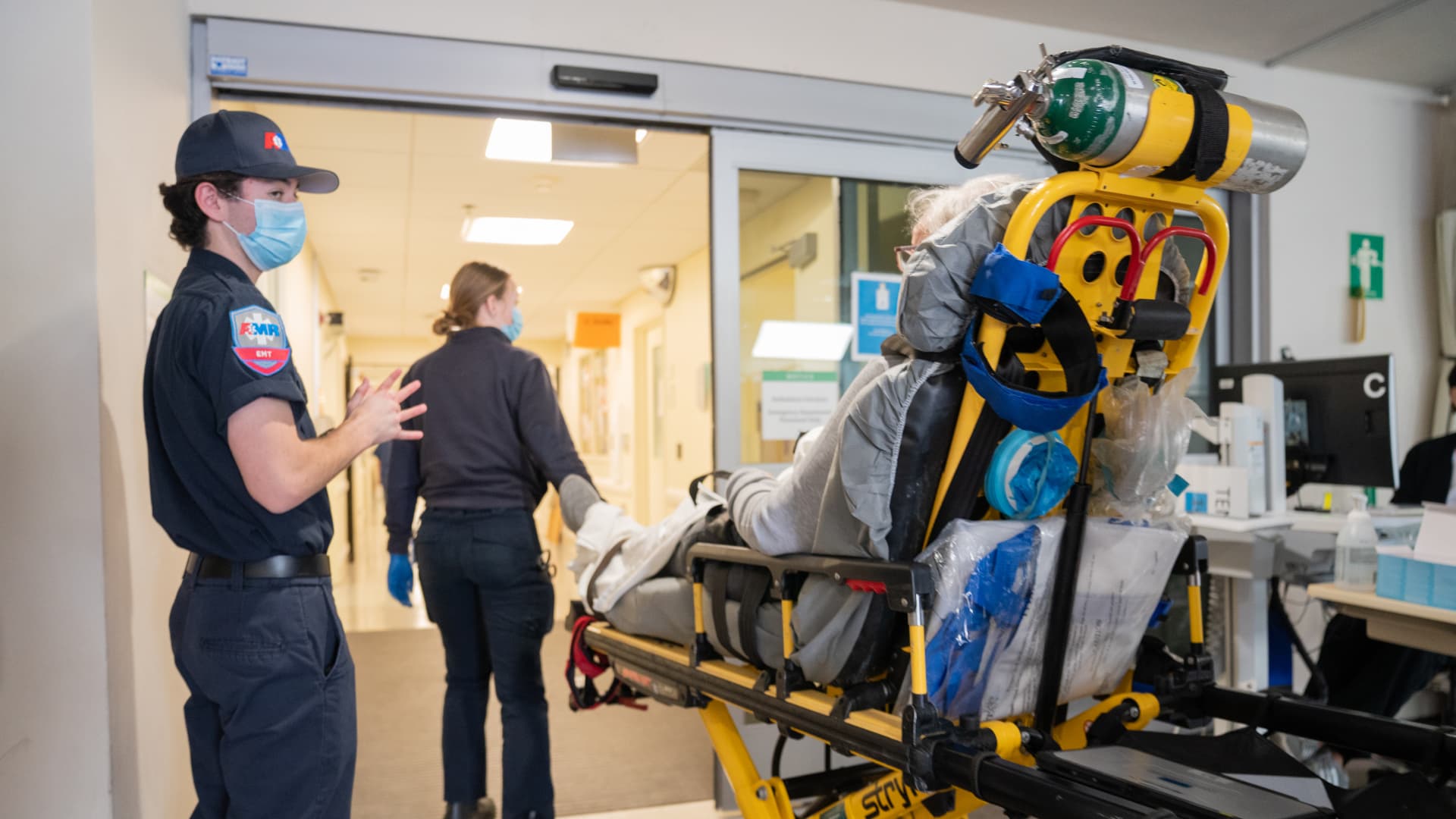 Paramedics arrive with a patient with Covid-19 at the emergency department of Sharp Memorial Hospital in San Diego, California.