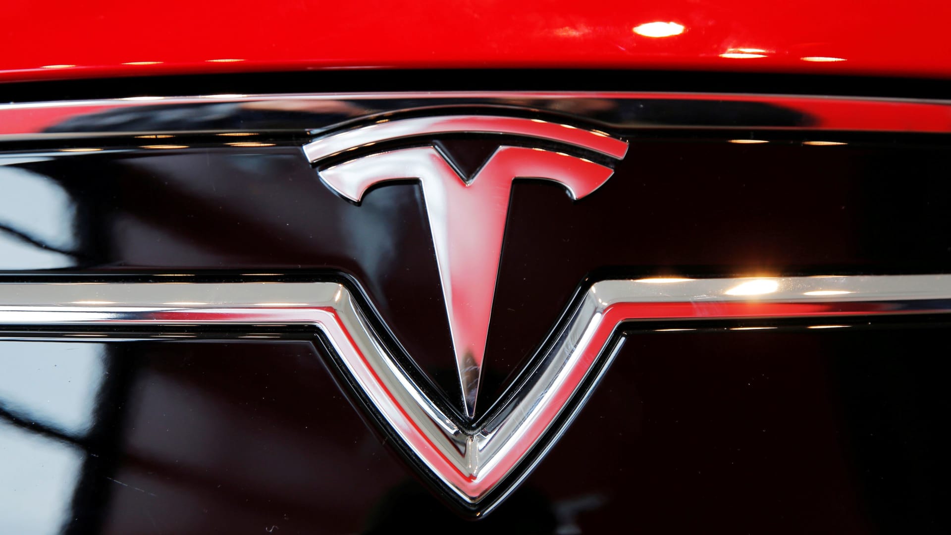 A Tesla logo on a Model S is photographed inside of a Tesla dealership in New York.