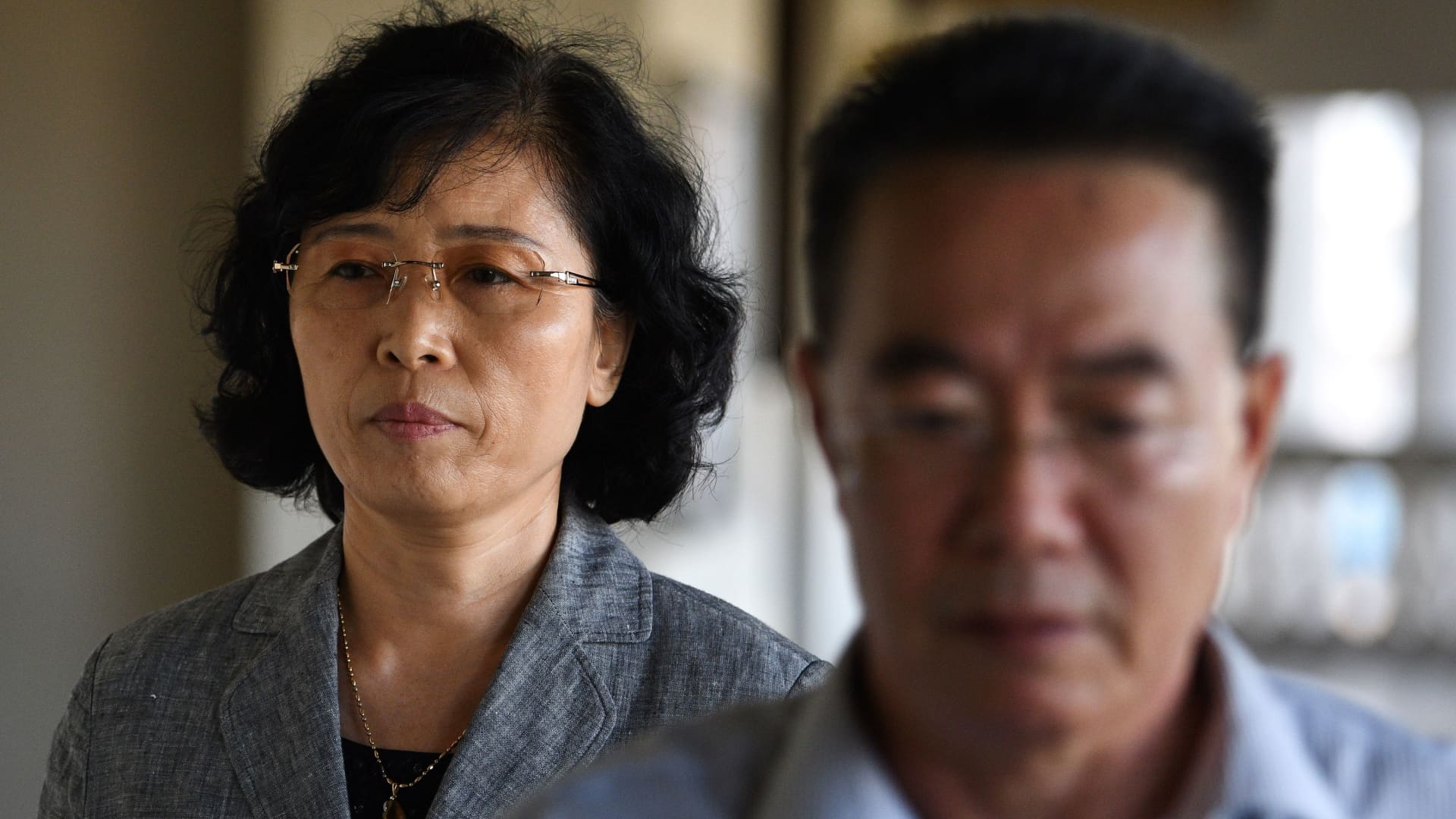 Kang Son Bi (L) wife of Mun Chol Myong, the North Korean man who faces possible extradition from Malaysia to the US on money-laundering charges arrives at the High Court in Kuala Lumpur on December 6, 2019.