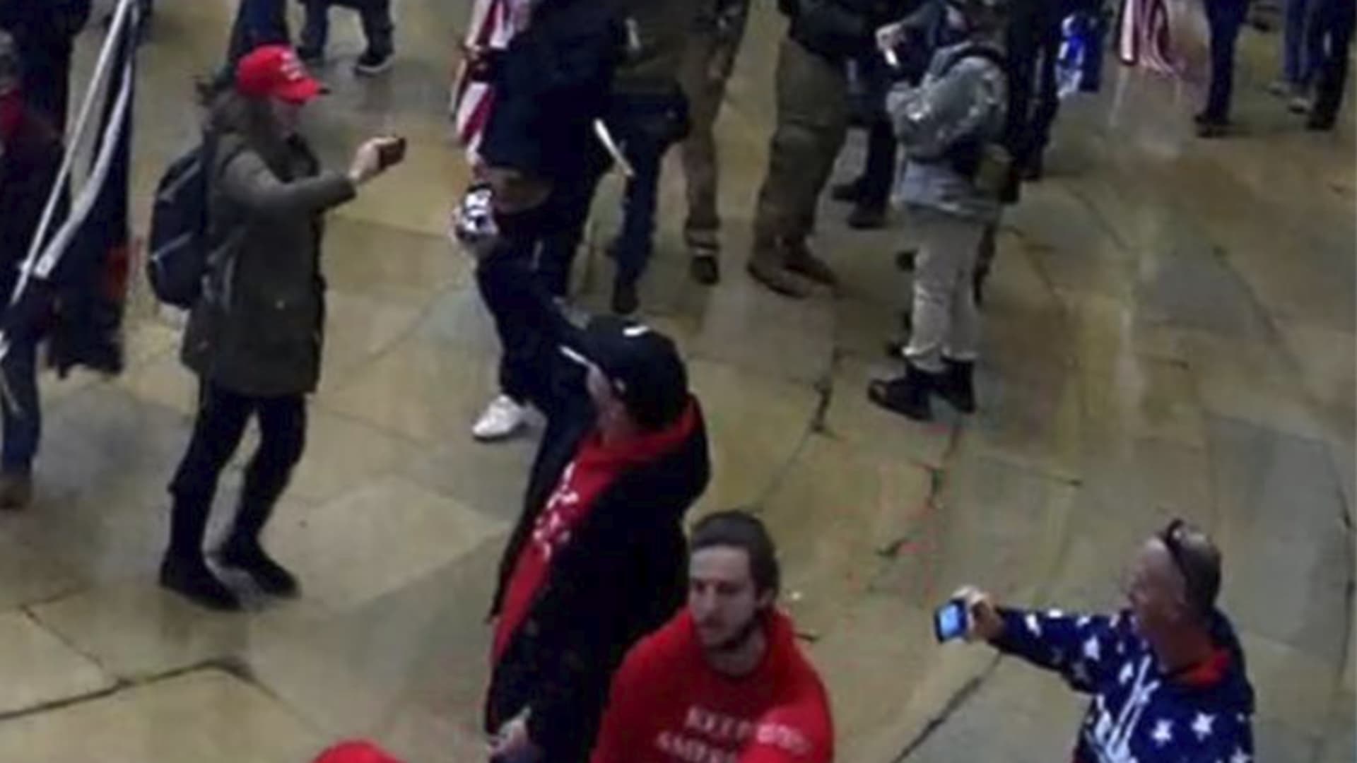 DOJ submits photos as part of a Statement of Facts, identifying Former NYPD officer Sara Carpenter (dressed in red hat, green jacket wearing a grey backpack), participating in the Capitol Riots on Jan. 6th, 2021.