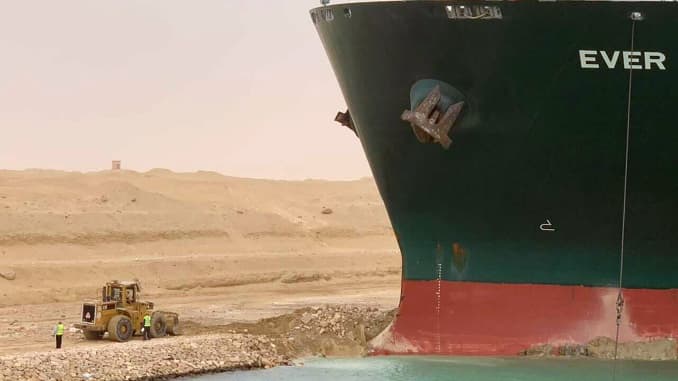 In this photo released by the Suez Canal Authority, a cargo ship, named the Ever Given, sits with its bow stuck into the wall Wednesday, March 24, 2021, after it turned sideways in Egypt's Suez Canal, blocking traffic in a crucial East-West waterway for g