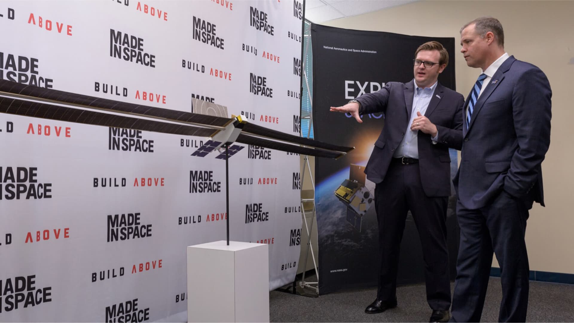 Redwire chief operating officer Andrew Rush shows former NASA administrator Jim Bridenstine a spacecraft model of subsidiary Made In Space.
