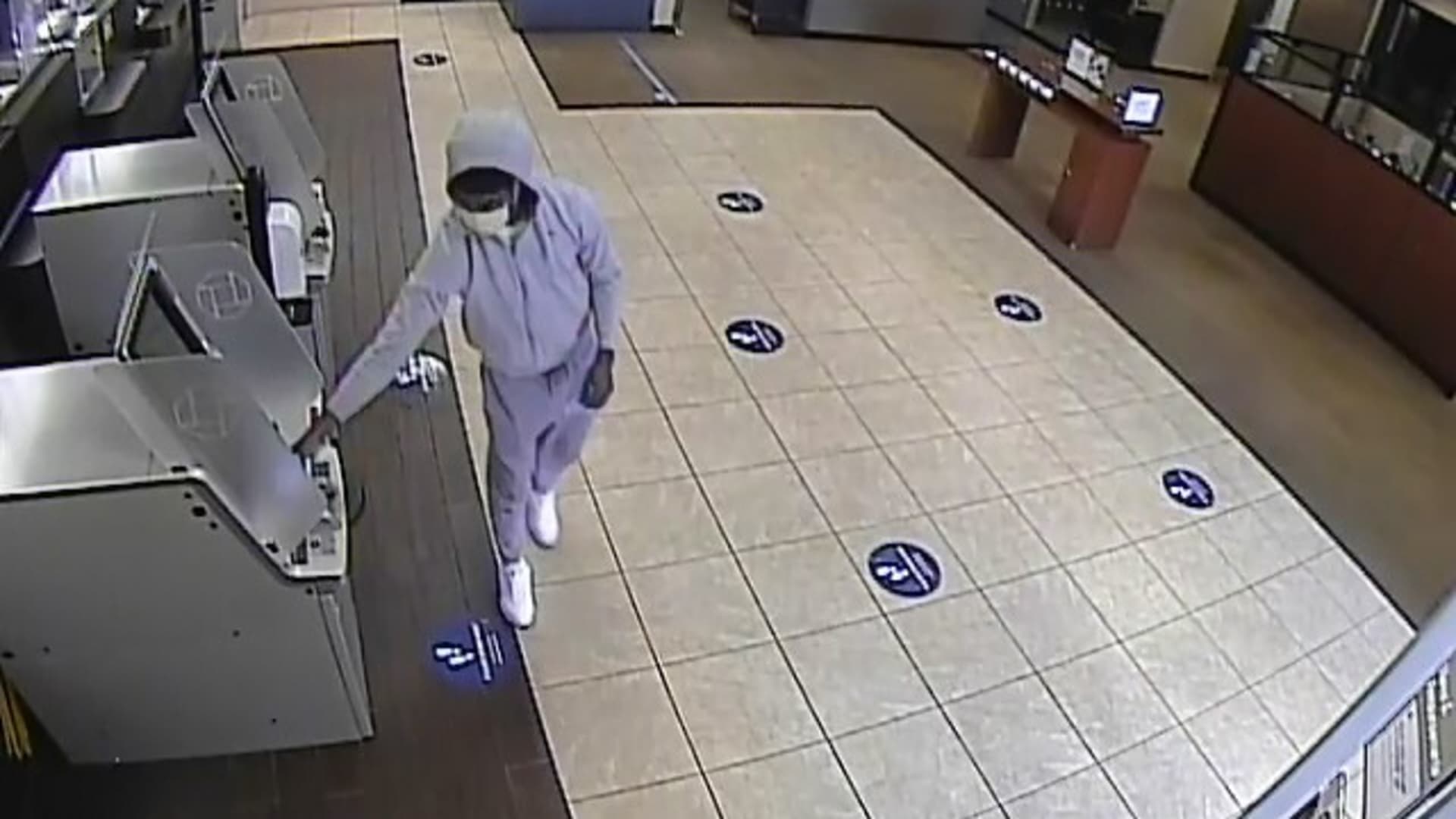 Security video shows a suspected fraudster trying to take money out of an ATM in a Chase bank in Boca Raton, Florida.
