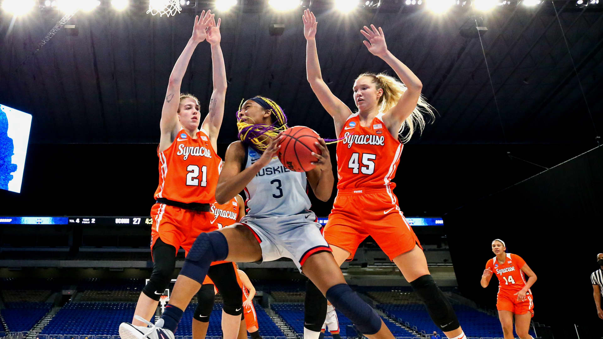 Aaliyah Edwards #3 of the UConn Huskies looks to pass against Emily Engstler #21 and Digna Strautmane #45 of the Syracuse Orange during the first half in the second round game of the 2021 NCAA Women's Basketball Tournament at the Alamodome on March 23, 2021 in San Antonio, Texas.