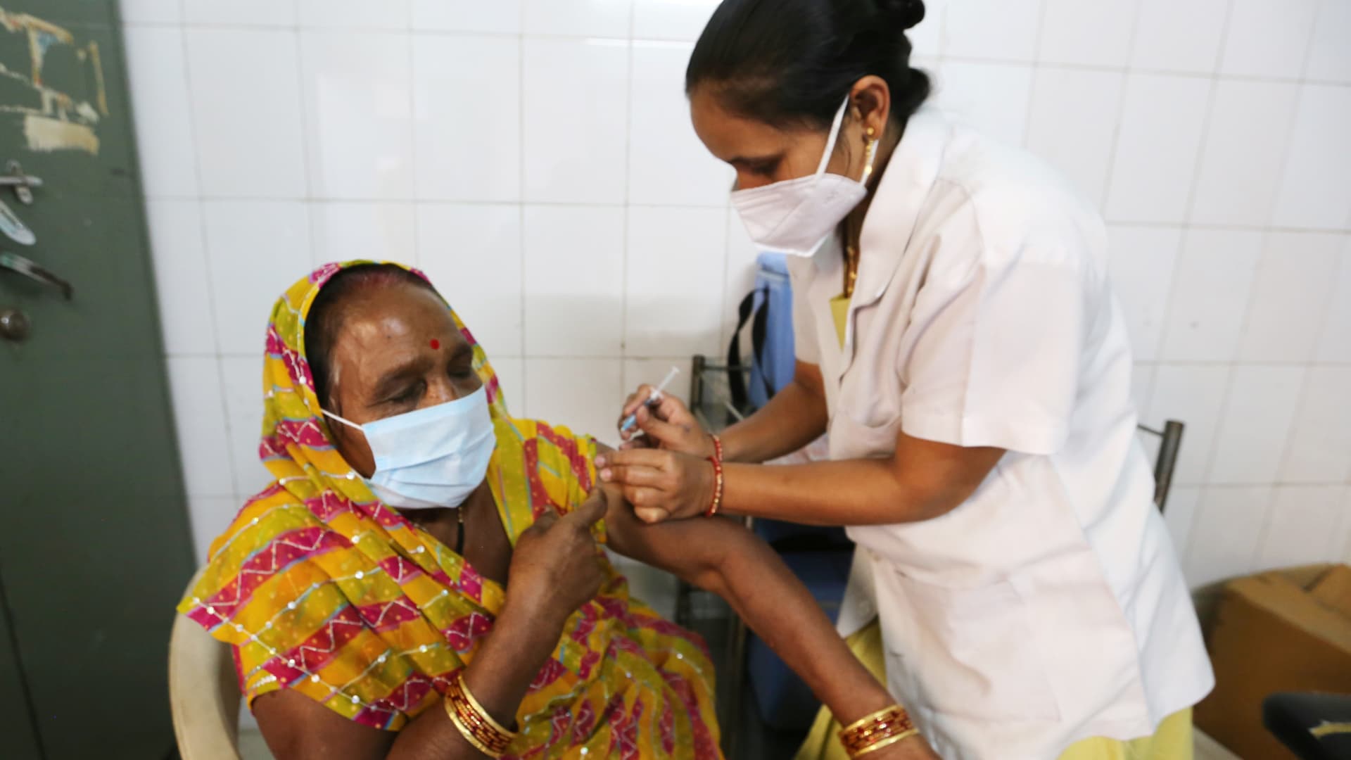 A health worker administers a dose of COVID-19 vaccine at a clinic in Bhopal, India, March 25, 2021.