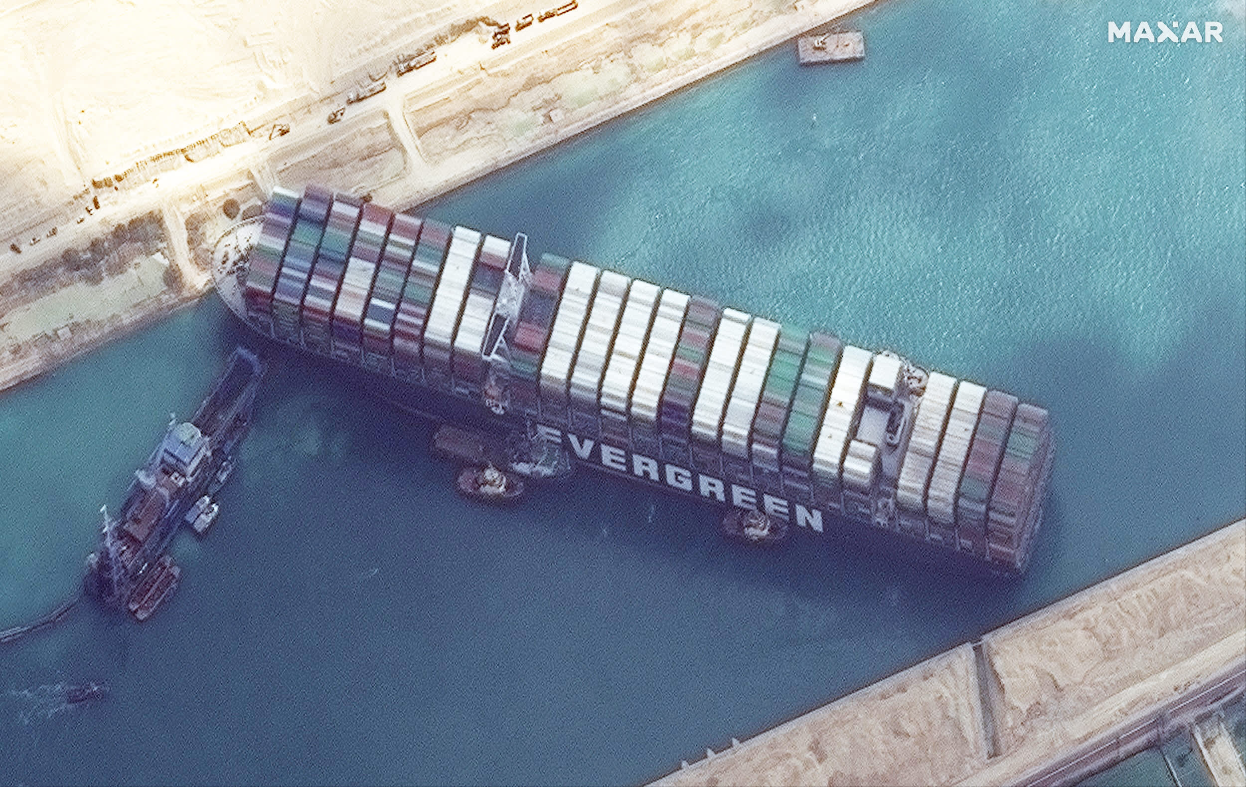 Satellite imagery shows work underway to free ship Ever Given in the