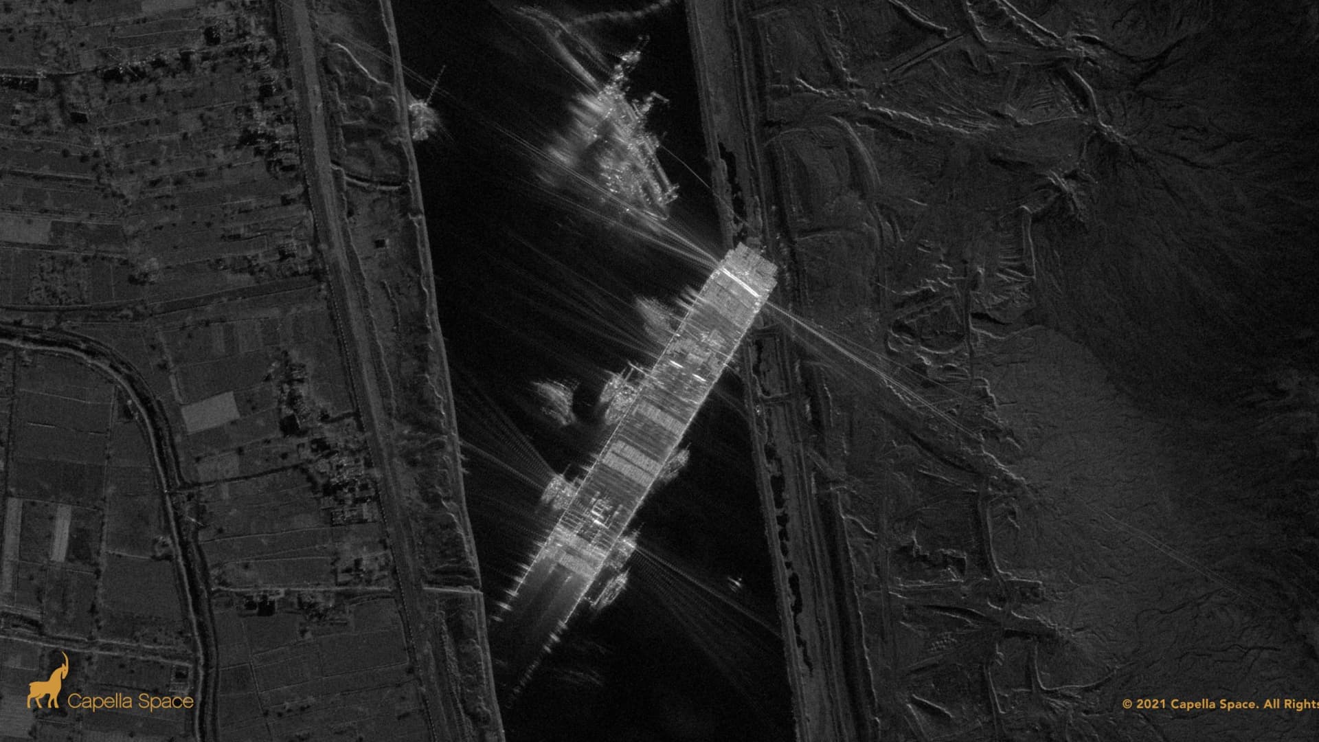 A synthetic aperture radar image captured by a Capella satellite on the evening of March 25 shows the Ever Given ship surrounded by support boats in the Suez Canal.