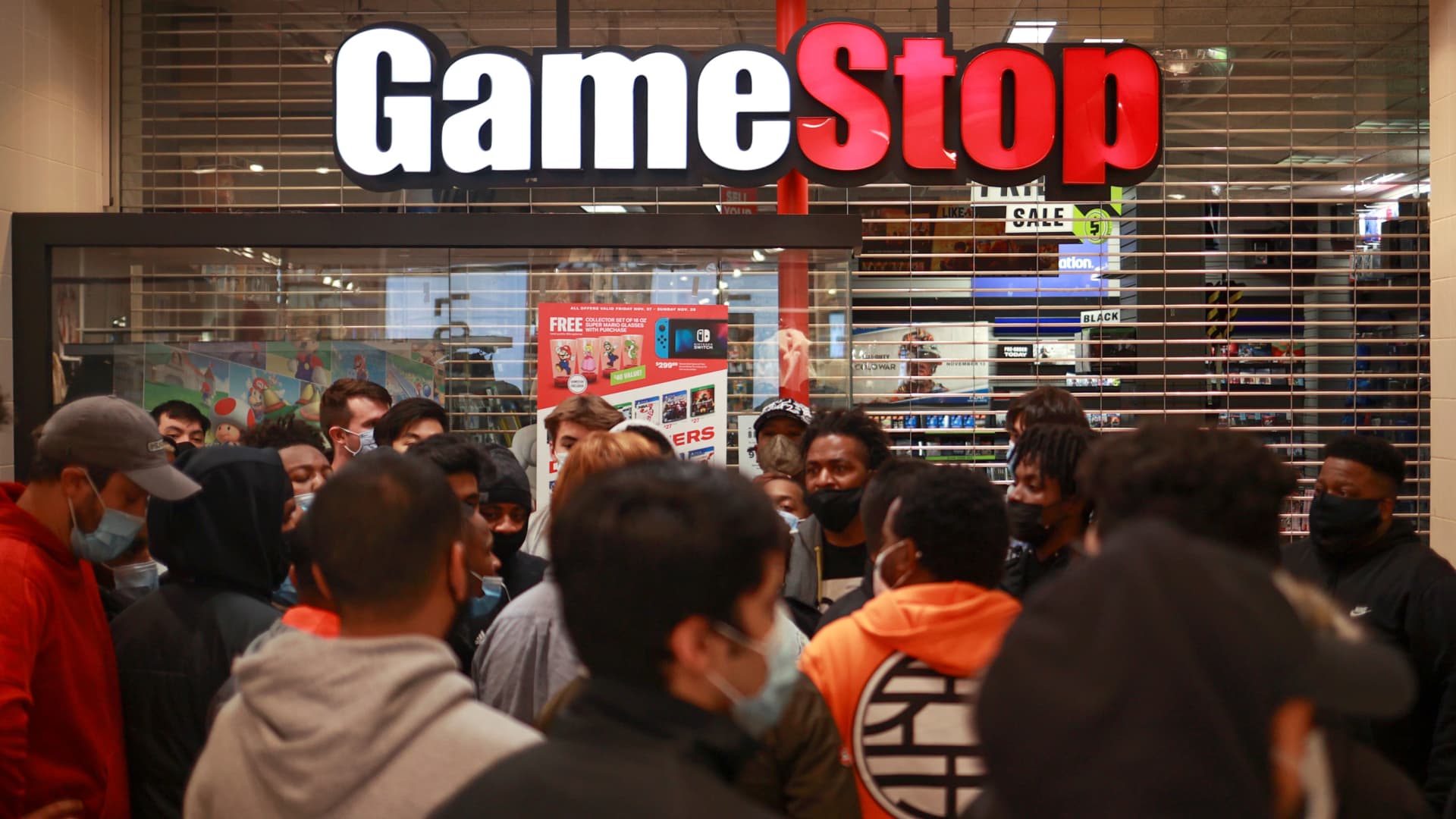 Shoppers wait for a GameStop store to open on at the Tysons Corner Center, in Tysons, Virginia, November 27, 2020.