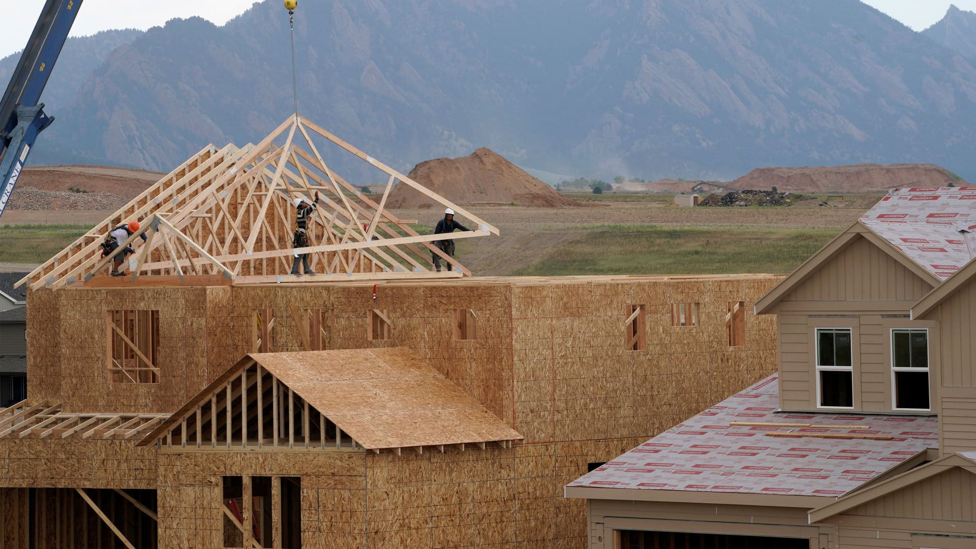 Workers install roof trusses onto a new house in Arvada, Colorado.