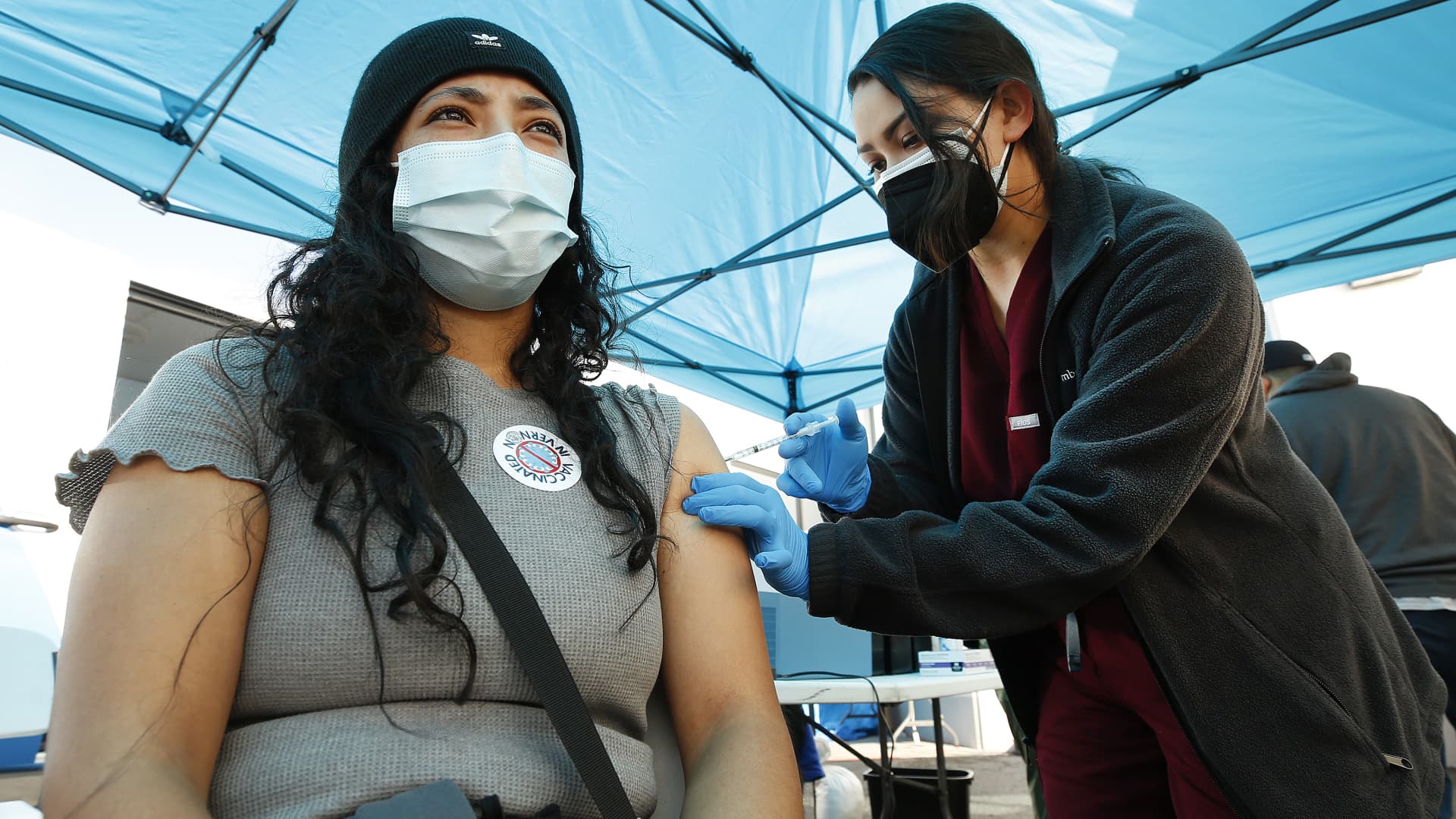 Elizabeth Raygoza gets her Pfizer vaccine shot, March 17, 2021, from Physician Assistant-Certified Alyssa Hernandez as the city of Vernon Health Department staff used the city's new mobile health unit clinic to administer COVID-19 vaccinations to nearly 250 essential food processing workers at Rose & Shore, a major, locally-based prepared foods products producer that serves supermarkets, schools, restaurants, airlines and others.