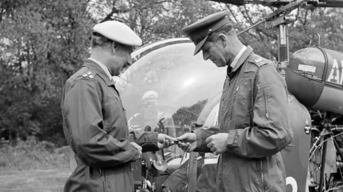 Prince Philip The Duke of Edinburgh, in flying overalls, being presented with his army wings by Bridgadier Colin Kennedy, Commandant of the Army Air Corps Centre, during the Duke's visit to the centre.