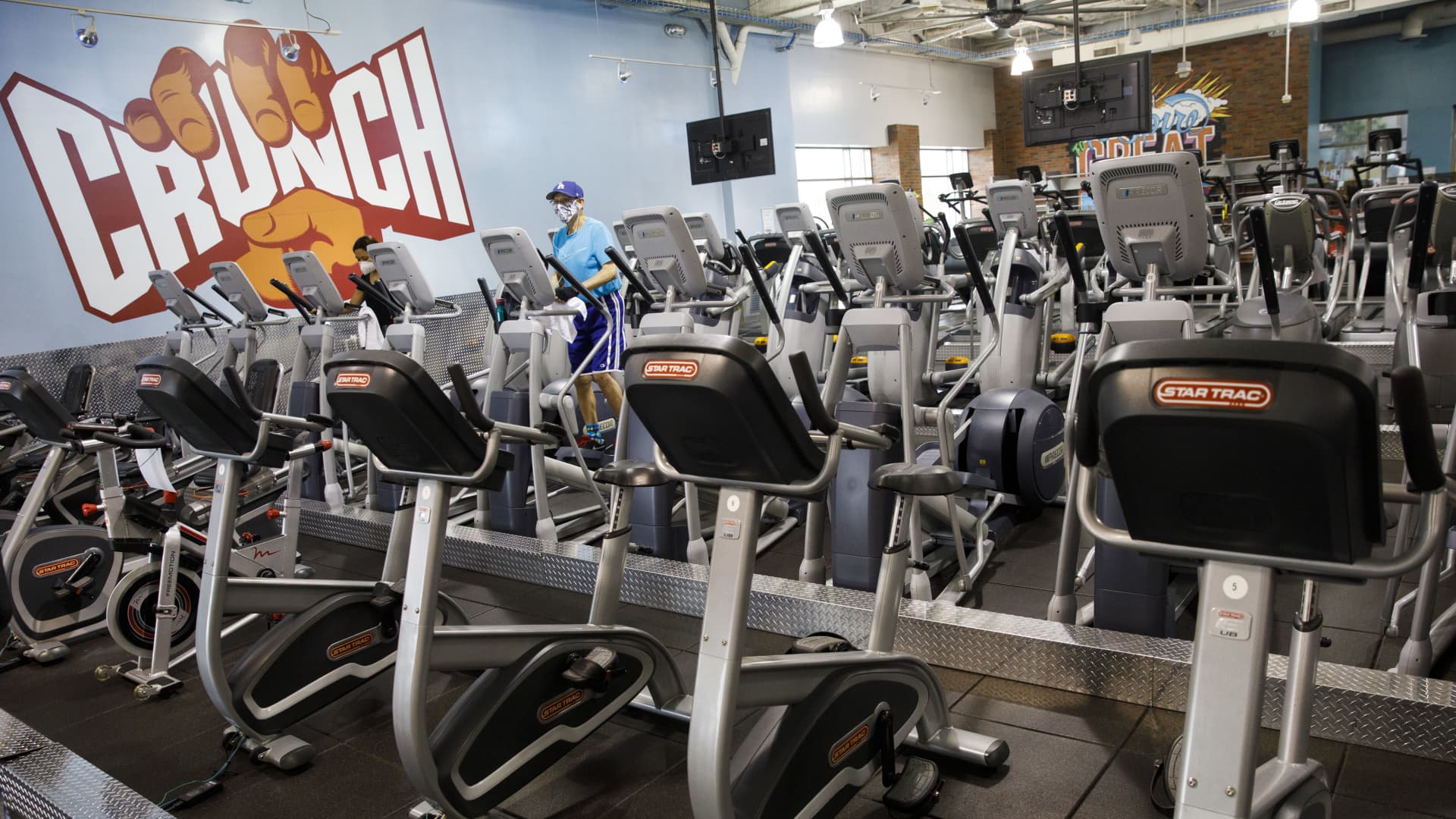 A person exercises on an elliptical machine at a Crunch Fitness gym location in Burbank, California, U.S., on Tuesday, June 23, 2020.