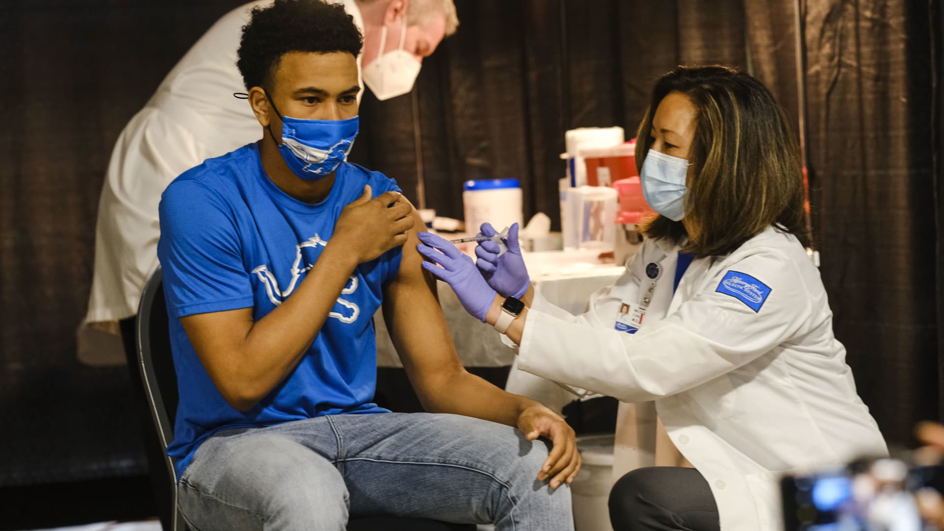 A group of teenagers serving as 'Covid-19 Student Ambassadors' joined Governor Gretchen Whitmer to receive a dose of the Pfizer Covid vaccine at Ford Field during an event to promote and encourage Michigan residents to go and get their vaccines on April 6, 2021 in Detroit, Michigan.