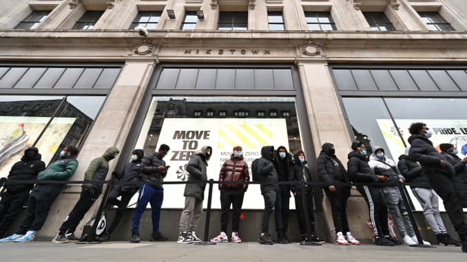 Shoppers queue outside a Nike store in central London as coronavirus restrictions are eased across the country on April 12, 2021.