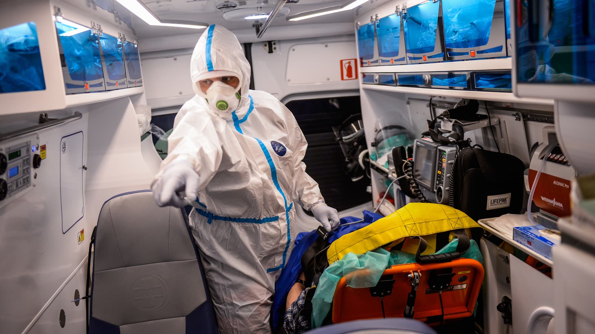 Bochnia Hospital paramedics wear protective equipment as they transport a patient suffering of COVID-19 to a local hospital on March 17, 2021 in Bochnia, Poland.
