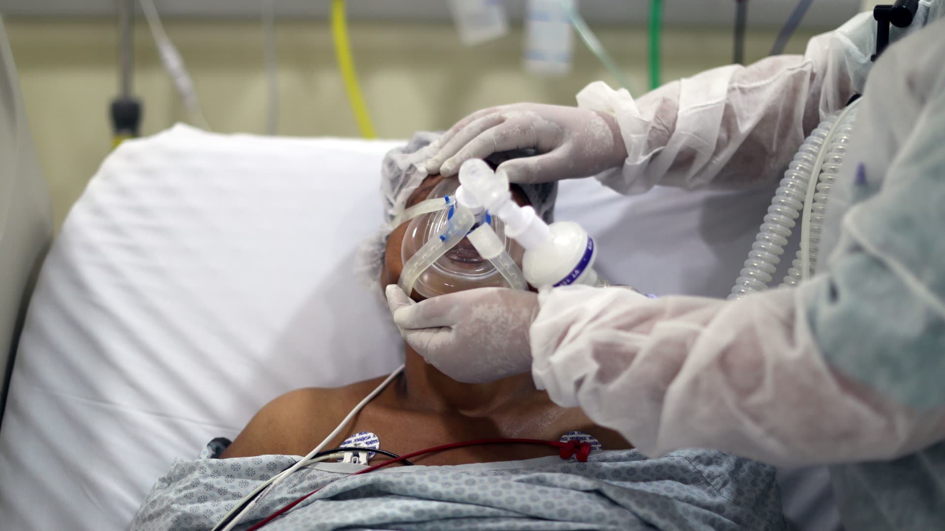 A physiotherapist adjusts an oxygen mask on a patient with coronavirus disease (COVID-19) disease at the ICU of Parelheiros Municipal Hospital in Sao Paulo, Brazil April 8, 2021.