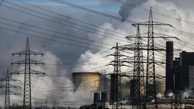 Electricity pylons are seen in front of the cooling towers of the coal-fired power station of German energy giant RWE in Weisweiler, western Germany, on January 26, 2021.