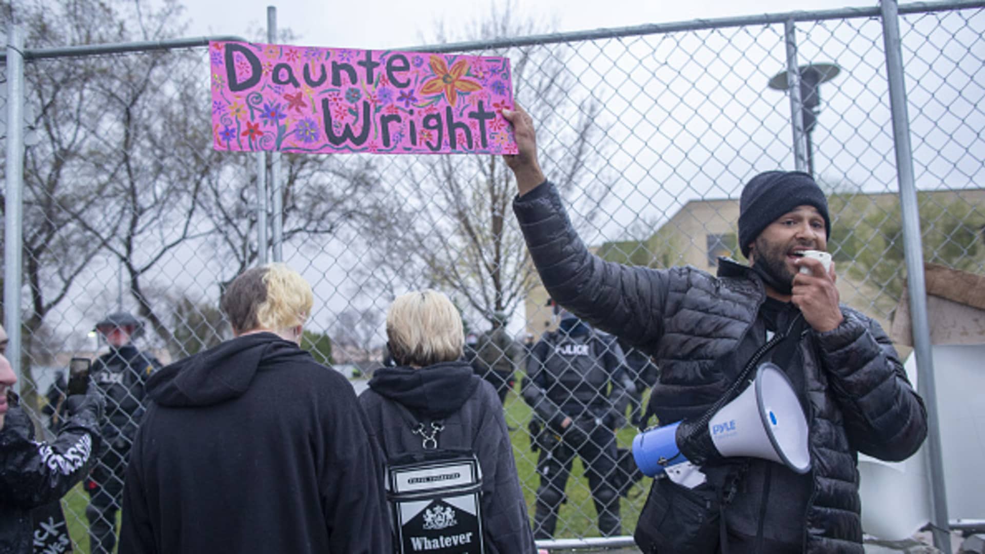 Activist Jonathan Mason holds a Daunte Wright sign in front of the crowd of protesters that gathered to protest the police killing of Daunte Wright in Brooklyn Center, Minnesota, U.S., on April 13, 2021.