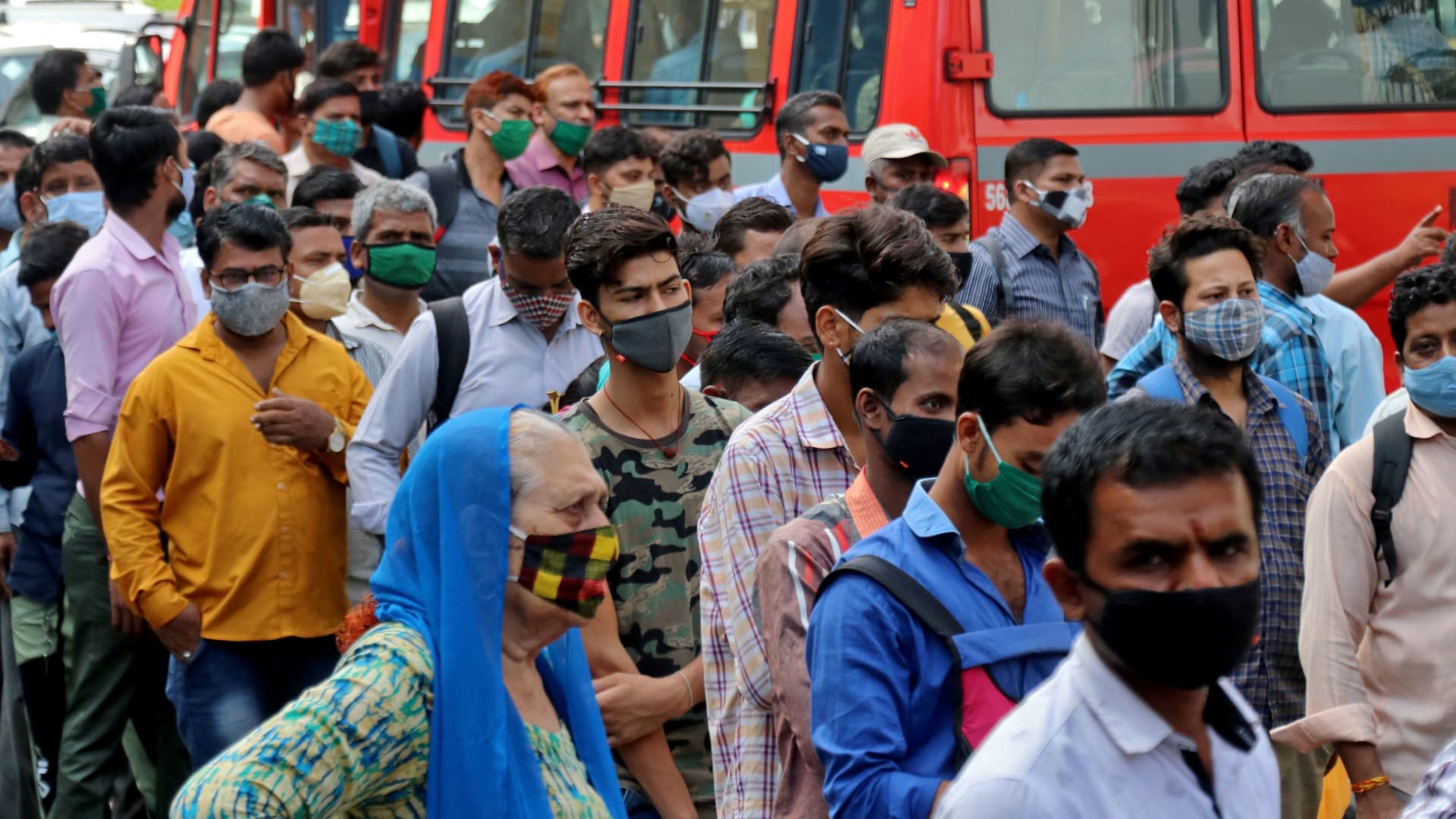 People wait to board passenger buses during rush hour at a bus terminal amidst the spread of the coronavirus disease (COVID-19), in Mumbai, India, April 5, 2021.