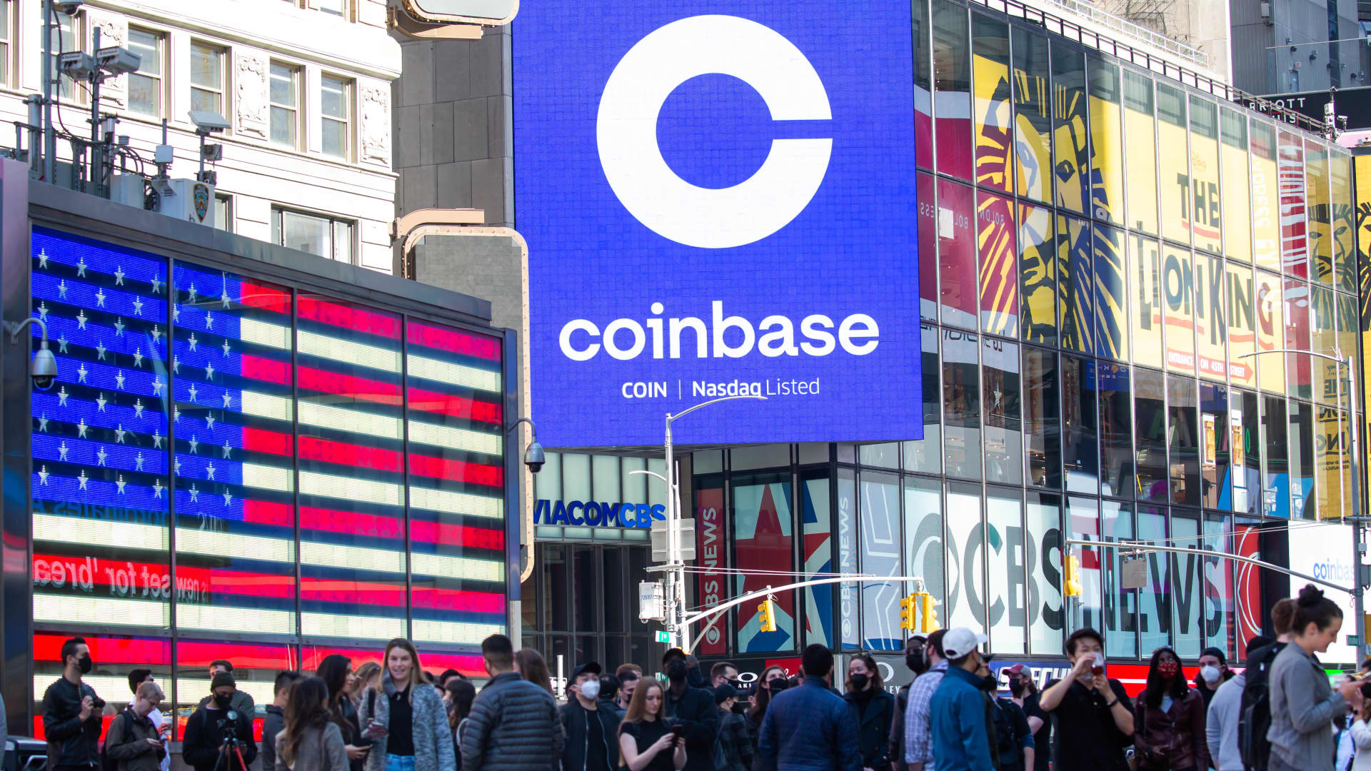 Monitors display Coinbase signage during the company's initial public offering (IPO) at the Nasdaq MarketSite in New York, on Wednesday, April 14, 2021.
