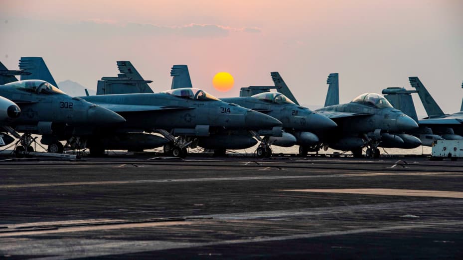 Sunset is seen behind fighter jets on the flight deck of United States Navy aircraft carrier USS Dwight D. Eisenhower (CVN 69) as it transits the Suez Canal in this picture taken April 2, 2021 and released by U.S. Navy on April 3, 2021.