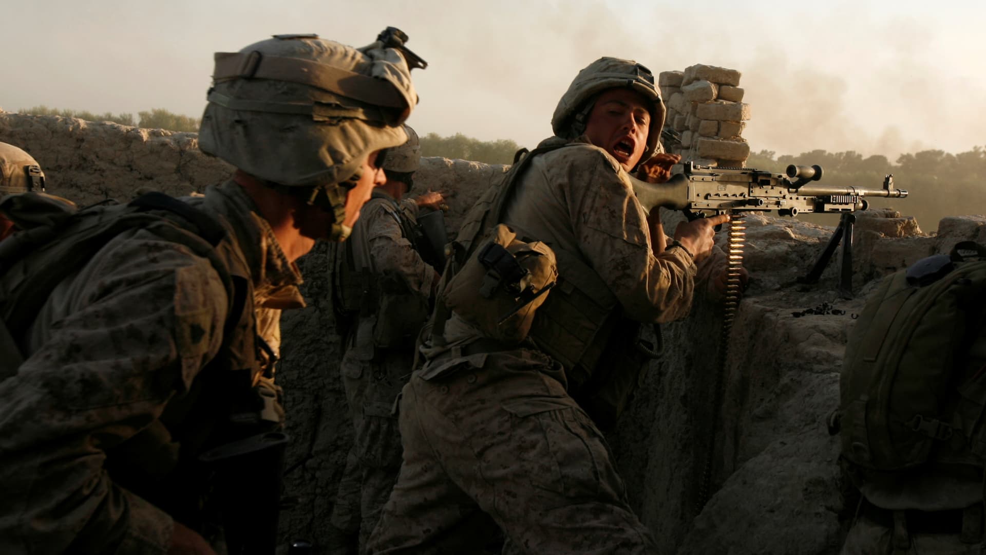 U.S. Marines fire during a Taliban ambush as they carry out an operation to clear an area in Helmand province, Afghanistan, October 9, 2009.