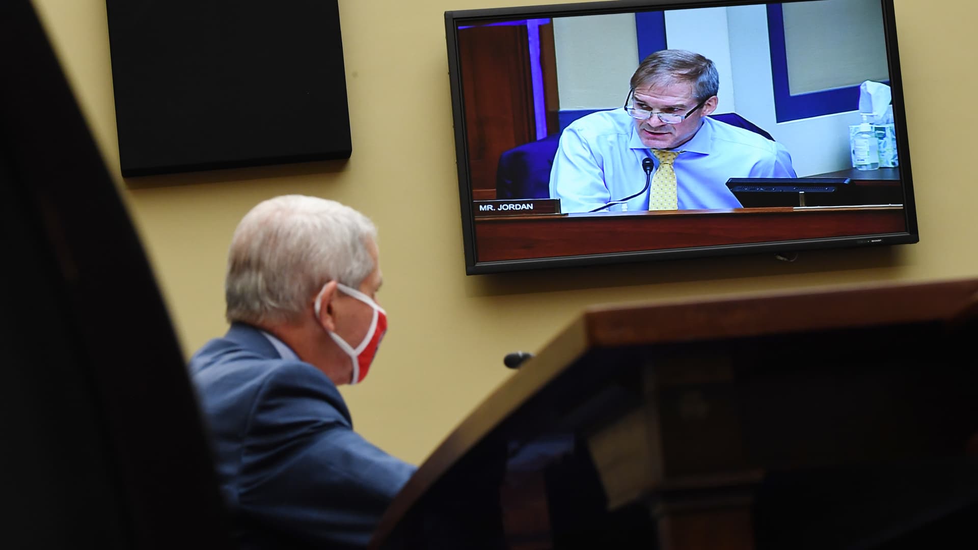 Dr. Anthony Fauci, director of the National Institute for Allergy and Infectious Diseases, listens as Rep. Jim Jordan, R-Ohio, is seen speaking on a monitor at a House Subcommittee on the Coronavirus Crisis hearing on July 31, 2020 in Washington, DC.