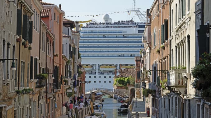 A cruise liner passes by the historic canals of Venice, Italy.