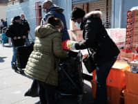 La gente espera en fila en un sitio de distribución de alimentos en el sur del Bronx el 10 de marzo de 2021 en Nueva York.