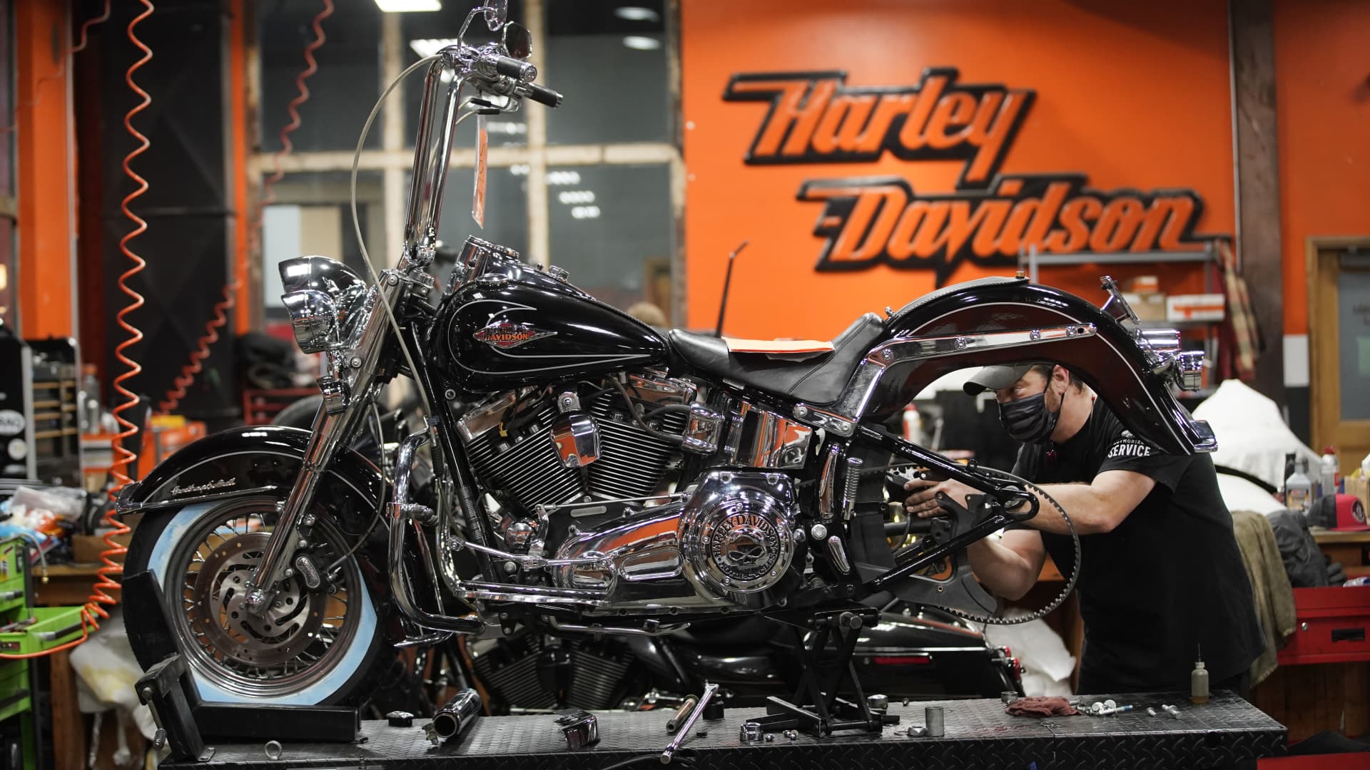A mechanic works on a motorcycle at a Harley-Davidson showroom and repair shop in Lindon, Utah, U.S., on Monday, April 19, 2021.
