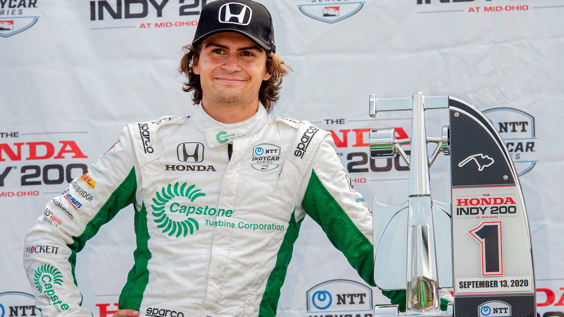 Colton Herta waits on the award stand after winning the IndyCar Series auto race, at Mid-Ohio Sports Car Course, Sunday, Sept. 13, 2020, in Lexington, Ohio.
